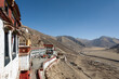DRIGUNG MONASTERY, TIBET: general view of colorful buildings and dry sunny winter landscape. Drigung Monastery is a notable monastery in the Lhasa Prefecture, Tibet, known for performing sky burials