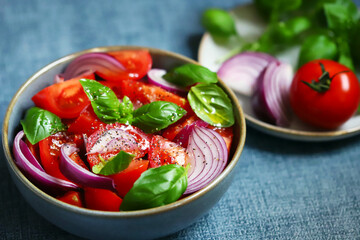 Wall Mural - Bright healthy salad with tomatoes, basil and blue onions.