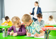 © JackF - Happy pupils chattering sitting at lesson in elementary school. High quality photo