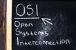 OSI Open Systems Interconnection - chalkboard text concept.