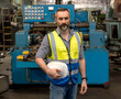 © Jack Tamrong - Handsome Caucasian engineer man holding safety hardhat standing and looking at camera in heavy machinery industrial factory, Engineer Concept