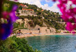 Villefranche sur Mer bay with palm trees and bougainvillea in South of France