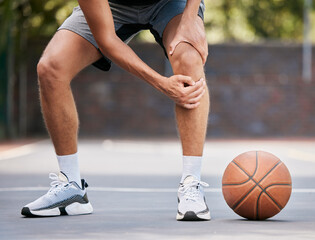 Poster - Pain, basketball and man with knee injury standing on outdoor court, holding leg. Sports, fitness and athlete with joint pain, injured and hurt in training, workout and game on basketball court