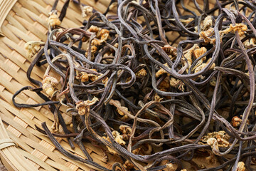 Wall Mural - close up Korean dried bracken or fernbrake Gosari in wood plate on wood table background. Korean herb dried bracken or fernbrake. Korean food dried bracken or fernbrake 