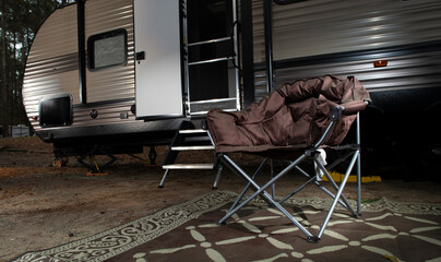 Wall Mural - Chair in front of a camping trailer