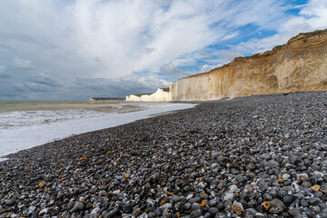 Poster - rocky beach at Birling Gap with the cliffs of the Seven Sisters in the background on the Jurassic Coast of East Sussex