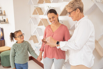 Canvas Print - Glasses, vision and children with a mother and daughter at the optometrist for an appointment to test prescription lenses. Family, consulting and eyewear with a woman customer buying frame lenses