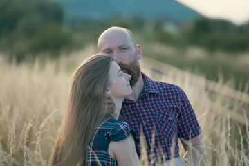 Canvas Print - Young couple in love in the summer field