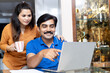 © Photographielove - couple using laptop in home for online shopping