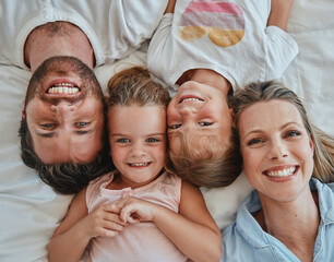 Poster - Happy family, love and above morning smile with parents and children lying and happy in bedroom for fun together at home. Laugh and man and woman love, care and happiness with girl kids to bond