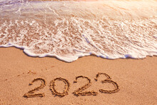 2023 Year Written On Sandy Beach Sea At Sunny Day