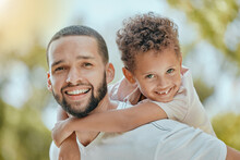 Dad, Family And Piggy Back Portrait With Happy Son In Park To Relax, Bond And Smile Together. Father, Happiness And Wellness Of Parent With Young Child Enjoying Outdoor Summer Fun In Nature.