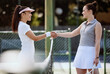 Tennis, sport and women handshake for competition, fitness and exercise on outdoor tennis court for health and active life. Athlete, friendly and competitive, smile with rival and ready for match.