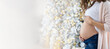 Banner pregnant woman holds her belly in late pregnancy against the backdrop bokeh of a Christmas tree mocap, copy space. Concept: IVF or healthy or surrogate motherhood, pregnancy, motherhood