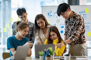 A group of young modern Asians is having a brainstorming meeting while sitting at work. Business meetings, planning, strategy, new business development online business ideas market competition.