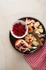 Wall Mural - Top view of fresh red pomegranate fruit and seeds on plate healthy food textile