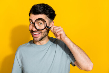 Sticker - Photo of cheerful satisfied man stylish clothes using magnifying glass find investigation empty space isolated on yellow color background