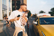 © BullRun - Cheerful man standing near taxi while kissing dog