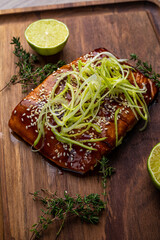 Sticker - salmon steak in grilled sauce on a wooden board