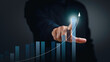 © Pheniti - Businessman point to analyzing financial graph on virtual screen. Business analysis, financial investment and technology concept.
