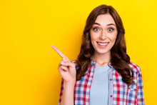 Photo Of Pretty Impressed Girl Dressed Checkered Shirt Pointing Finger Empty Space Isolated Yellow Color Background