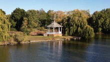 Aerial Shot Over A Small Bandstand Near A Lake In Watermead Park