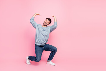 Wall Mural - Full size photo of handsome young man lifting up heavy copyspace feel pressure wear stylish blue garment isolated on pink color background