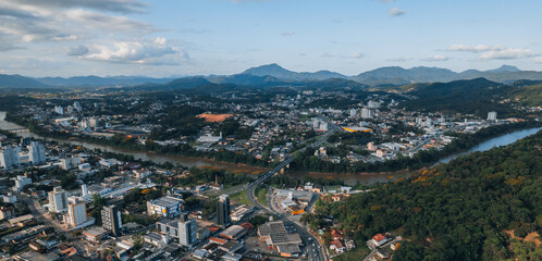 Wall Mural - 
aerial image of downtown Blumenau, with Itajaí Açú River, Santa Catarina, southern Brazil, buildings, main streets, vegetation and sunny day