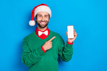 Poster - Photo of handsome guy indicate finger empty space telephone display isolated on blue color background