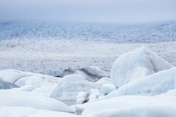 Sticker - Fjallsarlon glacier lake with floating ice caps against the foggy sky in Iceland