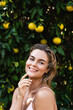© blackday - Portrait of beautiful woman with smooth skin against lemon trees