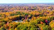 Aerial shot of a road hidden among colorful fall trees in Greensboro, NC Piedmont Triad