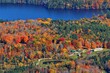 Beautiful scenery of countryside houses by the lake in a Fall Foliage field