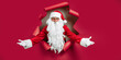 © ZaStock - Santa Clause peeking through hole on red paper while gesturing hands like welcome. New Year advert