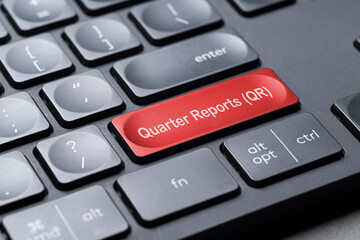 Quarter report (QR) on keyboard. Business financial performance, stock market.