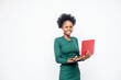 © wazkkii - Photo of cheerful creative cute nice freelance worker wearing bright vivvd Green shirt holding red laptop device with her hands working with technology isolated over white background