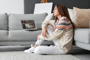 Wall Mural - Young woman video chatting with psychologist at home