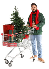 Sticker - Handsome man with shopping cart, Christmas tree and presents on white background