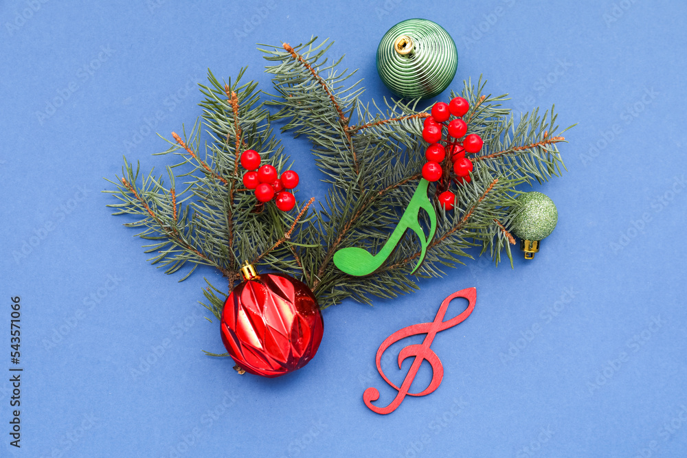 Note signs with Christmas balls, rowan and fir branches on blue background