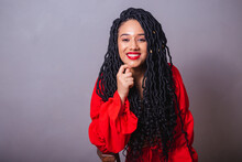 Beautiful Black Brazilian Woman, Dressed In Red. Portrait On Gray Background.