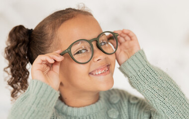 Canvas Print - Face portrait, child and girl with glasses for optical health at optometrist office. Eyes wellness, eye care and happy kid with specs, spectacles or prescription lenses to help with ocular vision.