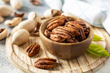 Nuts And Seeds, Healthy Fats, Various Trace Elements And Vitamins. Bowl With Pecan Nuts On A Stone Table.