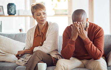 Wall Mural - Divorce, stress and mature couple arguing on the sofa in the living room of their house. Frustrated, relationship problems and upset African man and woman speaking in the lounge of their home.