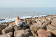 © shintartanya - Remote work.Girl freelancer works remotely on the sea shore. workation, remote work,WFVH,Van Life vibes work from vacation home,work travel,remotely work.Travelling.Work from vacation remotely