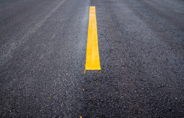 Asphalt road surface with yellow line