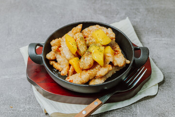 Wall Mural - Chinese food sweet and sour pork dish in black bowl