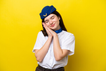 Wall Mural - Airplane stewardess Russian woman isolated on yellow background making sleep gesture in dorable expression