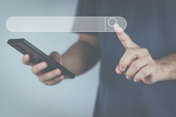 Wall Mural - The concept of using technology to search for information, a man's hand is using a smartphone to search for information on social media via the Internet online.