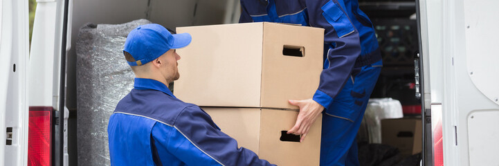 Wall Mural - Two Movers Carrying Cardboard Box