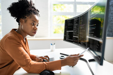 Computer Programmer Writing Program Code On Computer